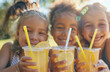 © pilipphoto - Group of mix raced children holding natural lemonade in park