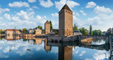 Fototapeta Tulipany - The towers of The Ponts Couverts in Strasbourg with blue cloudy sky. France.