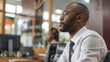© VK Studio - Focused businessman in a sleek office staring intently into the distance.