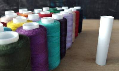 colorful spools of thread for embroidery close up background