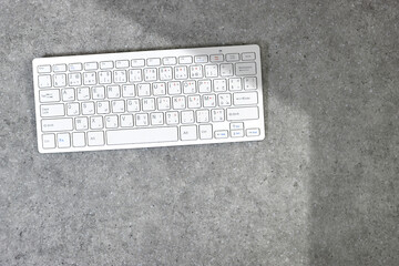 Wall Mural - Modern aluminum computer keyboard isolated on grunge gray background