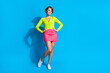 Full length photo of young bob brown hair woman in pink mini skirt green cardigan touch her fit waist isolated on cyan color background