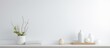 © Lasvu - Minimal interior design with white table and various decorative elements on a shelf
