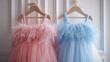 Beautiful dressy lush pink and blue dresses for girls on hangers at the background of white wall.. generative ai 