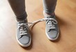 Man with shoelaces tied together. April fool's day prank