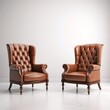 Pair of classic tufted leather wingback chairs on a clean, white background, showcasing timeless elegance.
