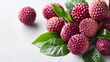 Collection of lychee fruits on white. Group of ripe lychees with green leaves. Fresh lychees display on a bright background.