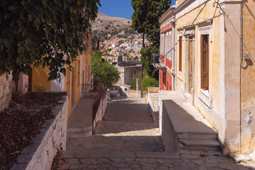 Wall Mural - Old narrow traditional street in the Greek village of Symi.