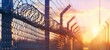 Close up of the edge of an industrial fence with barbed wire at sunset Generative AI