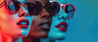 Three women wearing colorful sunglasses - A stylish image featuring three women with vibrant lipstick and stylish sunglasses against a blue-lit background