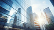© MP Studio - Low-angle view of towering skyscrapers with reflective glass facades against a backdrop of blue sky and sunlight in an urban cityscape.