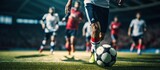 Fototapeta Sport - Photo shot of legs Soccer player running dribbling after the ball in stadium soccer
