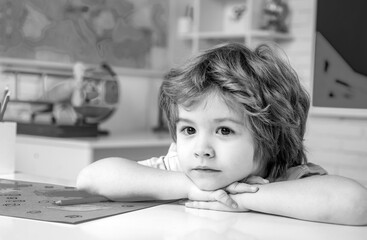 Fototapete - Little children at school lesson. Kid is learning in. Portrait of Pupil of primary school study indoors. School kids.