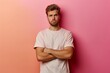 © Jorge Ferreiro - Young Man Standing With Arms Crossed in Front of Pink Wall