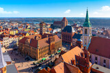 Fototapeta Góry - Aerial panoramic view of historical buildings and roofs in Polish medieval town Torun