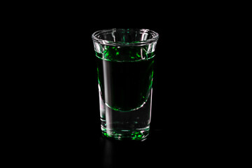 shot glass with green drink