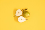 Fototapeta Tulipany - Yellow pears pattern. Close up of pear on yellow background. Autumn fruit concept from ripe juicy pears. Flat lay, top view
