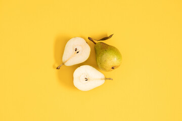 Yellow pears pattern. Close up of pear on yellow background. Autumn fruit concept from ripe juicy pears. Flat lay, top view