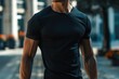 man with muscular body wearing a tight black t shirt