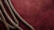 A detailed close-up of a taut rope against a vibrant red backdrop