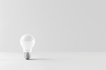 Canvas Print - A white light bulb sitting on top of a table. Suitable for various concepts and ideas.