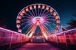 A neon lit ferris wheel at an amusement park