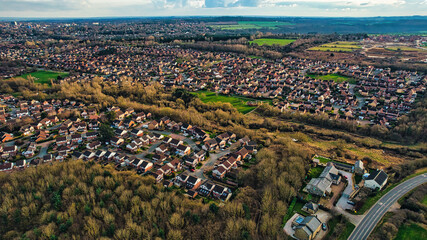 aerial view of a suburban area with houses and green spaces, showcasing a mix of residential living 