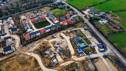 Aerial view of a residential construction site with partially completed houses and infrastructure in Harrogate, North Yorkshire.