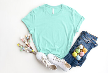 Wall Mural - Mint cotton Tshirt mockup with easter eggs , jeans, sneakers on white background. Design mint, green, 
aquamarine t shirt template, print presentation mock up. 3001 Top view flat lay.