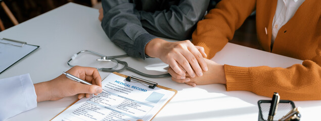 Couple attend fertility or medical consultation with gynecologist at hospital as family planning care for pregnancy. Husband and wife consoling each other through doctor appointment. Panorama Rigid