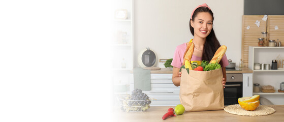 Poster - Young Asian woman with bag full of fresh products in kitchen. Banner for design