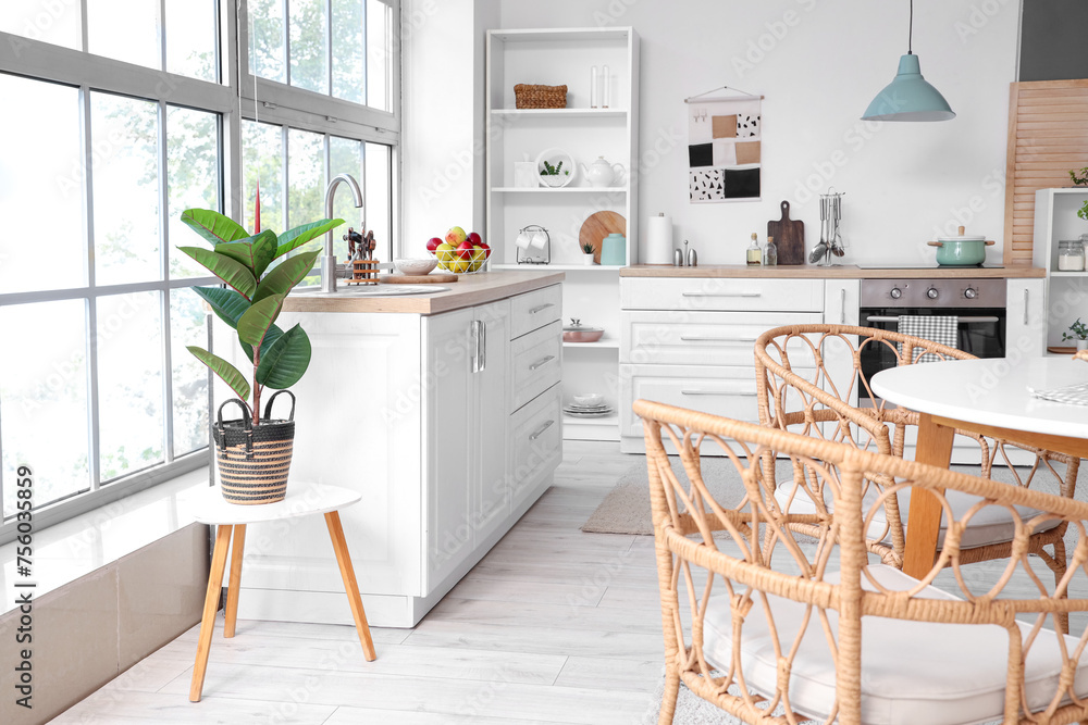 Interior of kitchen with counters and dining table