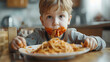 A little boy sitting at a table with a plate of food. Ideal for food-related content or family meal themes