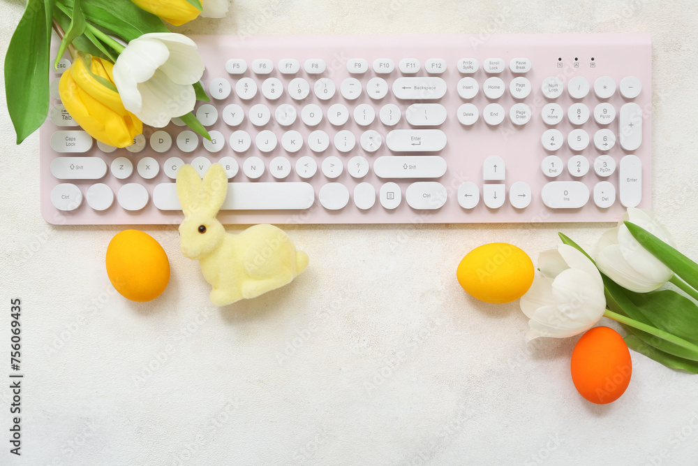 Composition with modern keyboard, tulip flowers and Easter decor on light background