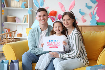 Sticker - Happy family in bunny ears holding paper with text EASTER SALE at home