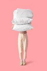 Sticker - Woman with stack of white pillows and folded blanket on pink background