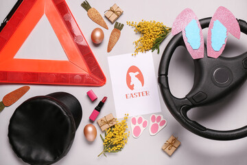 Poster - Composition with warning triangle, steering wheel, lipstick and Easter decor on grey background