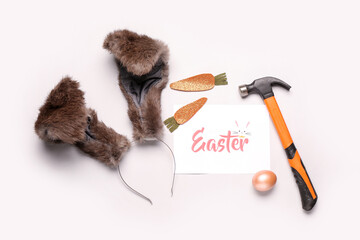 Poster - Card with text Easter, bunny ears, hammer and decor on light background