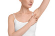 Woman showing armpit with smooth clean skin on white background, closeup