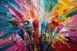 A dynamic array of paintbrushes with bristles coated in a vibrant explosion of multicolored paint splashes.
