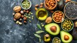 Assorted healthy fats with avocado, nuts, seeds, and olive oil on wooden background, space for text.