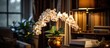 Orchids illuminated on a side table in a living room with golden lighting.