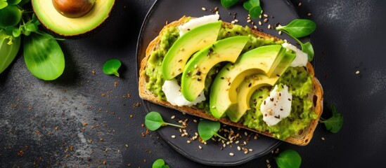 Sticker - A close up of a delicious sandwich featuring avocado and cheese on a plate. This mouthwatering combination of ingredients showcases the perfect blend of natures bounty in culinary art