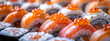 Assorted sushi rolls with fish roe on top, served on a black surface.