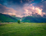 Fototapeta Na ścianę - Dramatic summer sunrise in Caucasus mountains. Fantastic morning scene of mountain pppasture in Upper Svaneti, Georgia, Europe. Beauty of countryside concept background..