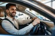 © ffunn - Handsome young man is driving a car and smiling. He is sitting on the steering wheel and looking at camera