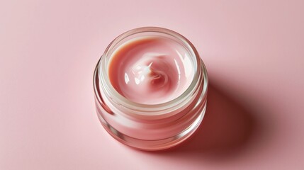 Wall Mural - Small jar of pink cream sits on pink background