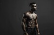 © MediaRaw - A man with a muscular body stands in front of a dark background