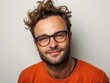 © BetterPhoto - A man with glasses is smiling and wearing an orange shirt