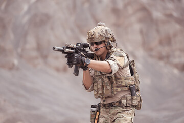 Soldiers in camouflage military uniforms carrying weapons, Reconnaissance missions in rugged mountains, Assault infantry battle training.